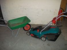 A BOSCH ELECTRIC MOWER AND A WHEELBARROW