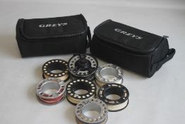A GREYS GRX1 7/8 SPOOL REEL and six spare spools and two zipped padded pouches