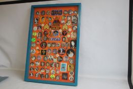 A FRAMED COLLECTION OF CIRCA 130 ELVIS PRESLEY PIN AND CLOTH BADGES, 96 cm x 66 cm