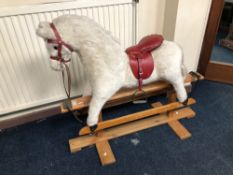 A VINTAGE ROCKING HORSE with saddle