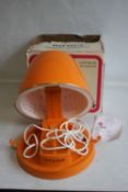 A VINTAGE RETRO ORANGE CASQUE-VALISE CALORBOXED PORTABLE HAIRDRYER, in box with instruction book