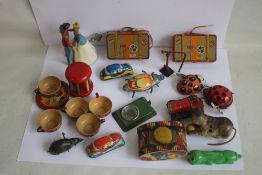 A COLLECTION OF TIN PLATE ITEMS MOSTLY WIND UP, SOME WITH KEYS, to include Cinderella and Prince