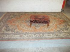 A LARGE RUG AND AN ANTIQUE FOOTSTOOL