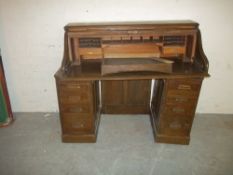AN ANTIQUE TWIN PEDESTAL ROLL TOP DESK