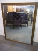 A LARGE BEVEL EDGED MIRROR