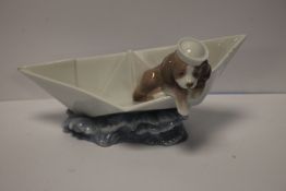 A LLADRO DOG IN A BOAT