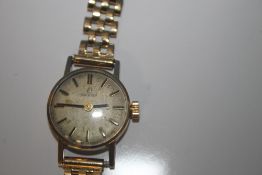 A LADIES OMEGA MANUAL WIND WRIST WATCH on an unbranded 9 ct gold strap, dedication inscription to