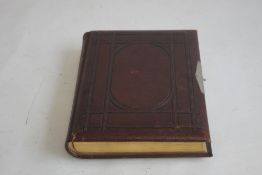 A VICTORIAN LEATHER BOUND PHOTOGRAPH ALBUM WITH CONTENTS, mainly portraits some decorated pages