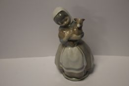 A NAO STYLE FIGURINE of a girl with calf