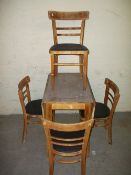 A VINTAGE DROP LEAF FORMICA KITCHEN TABLE AND FOUR CHAIRS