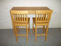 A HIGH BENCH DINING TABLE AND TWO TALL CHAIRS