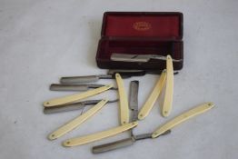 A BOXED SET OF SEVEN KOUSS CUT THROAT RAZORS, each inscribed on the edge with a day of the week