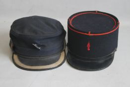 A VINTAGE BRITISH RAIL CAP WITH BLUE BADGE, and a vintage French fireman's cap