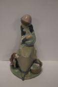 A LLADRO FIGURINE OF A GIRL AND LAMB