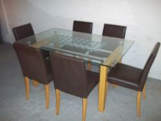 A GLASS DINING SET WITH SIX FAUX LEATHER CHAIRS