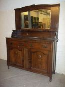 AN ANTIQUE OAK MIRROR BACKED WALL UNIT / SIDEBOARD