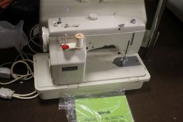 A CASED NEW HOME SEWING MACHINE