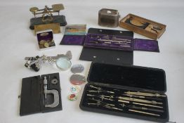 A BOX OF COLLECTABLES, to include postal scales, money box, weights, drawing sets etc