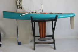 A LARGE VINTAGE FIBRE GLASS AND WOOD YACHT AND STAND, 160 cm long with sail