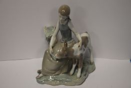 A LLADRO FIGURINE OF A GIRL AND CALF
