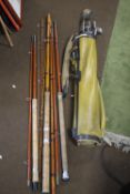 THREE VINTAGE FISHING RODS together with a collection of golf clubs