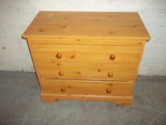 A THREE DRAWER CHEST OF DRAWERS