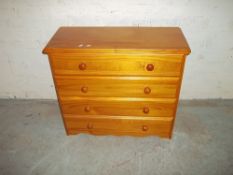 A PINE FOUR DRAWER CHEST OF DRAWERS
