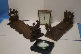 TWO WOODEN BOOK STANDS, A MANTEL CLOCK AND A MAGNIFYER