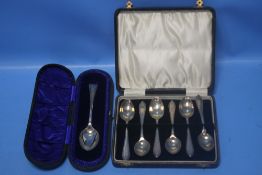 A CASED SET OF HALLMARKED SILVER TEASPOONS together with another cased spoon