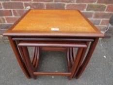 A RETRO TEAK NEST OF THREE TABLES - W 50 cm