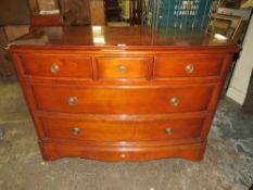 A MODERN BRIGITTE FORESTIER CHERRYWOOD BOW FRONT CHEST OF FIVE DRAWERS H- 84 CM W-125 CM