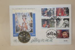 A £5 COIN AND STAMPS CELEBRATING QUEEN ELIZABETH II 40TH JUBILEE