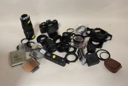 A BAG OF CAMERA ACCESSORIES, LENSES ETC