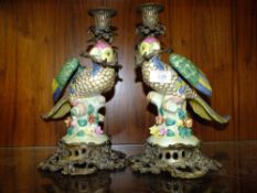 A PAIR OF MODERN CERAMIC AND METAL PARROT CANDLE STICK HOLDERS