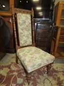 AN EDWARDIAN UPHOLSTERED PRAYER CHAIR