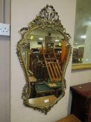 A SHAPED GILT WALL MIRROR WITH RIBBON EFFECT H-90 CM