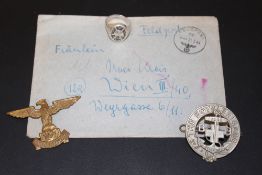 A GERMAN LETTER AND PHOTOGRAPH, NAZI RING, AND BADGES