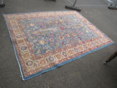 A LARGE EARLY 20TH CENTURY WOOLLEN RUG MAINLY BLUE GROUND 300 X 240 CM A/F - Threadbare in places