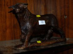 A CARVED WOODEN BULL