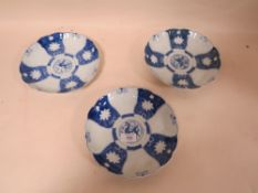 THREE ORIENTAL STYLE BLUE AND WHITE PLATES, having scalloped edging and character mark to base, Dia