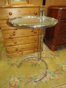 AN 'EILEEN GREY' GLASS TOP ADJUSTABLE TABLE