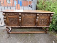 A LARGE CARVED HEAVY OAK SIDEBOARD IN THE JACOBEAN STYLE - H 93 cm, W 182 cm