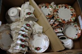 A TRAY CONTAINING TWO VINTAGE CHINA TEA SETS BY ROYAL WINDSOR AND PARAGON