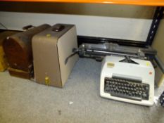 A VINTAGE OLYMPIA TYPEWRITER TOGETHER WITH A CASED VINTAGE SINGER ELECTRIC SEWING MACHINE TOGETHER