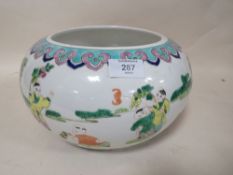 AN ORIENTAL CHINESE STYLE LOW BOWL, with scenes of children playing and flying kites, character ma