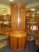 A 'NATHAN' MODERN TEAK GLASS FRONTED FULL-LENGTH CORNER CABINET H-197 CM W-77 CM