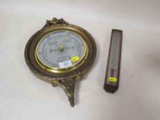A CIRCULAR WALL MOUNTED BAROMETER TOGETHER WITH A SMALL WOODEN CASED THERMOMETER