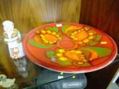 A LARGE POOLE POTTERY CHARGER AND A CERAMIC FIGURE