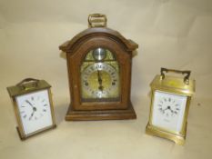 AN OAK CASED MANTEL CLOCK TOGETHER WITH TWO CARRIAGE CLOCKS