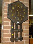 AN ARTS AND CRAFTS WOODEN WALL CLOCK WITH LACKING PENDULUM